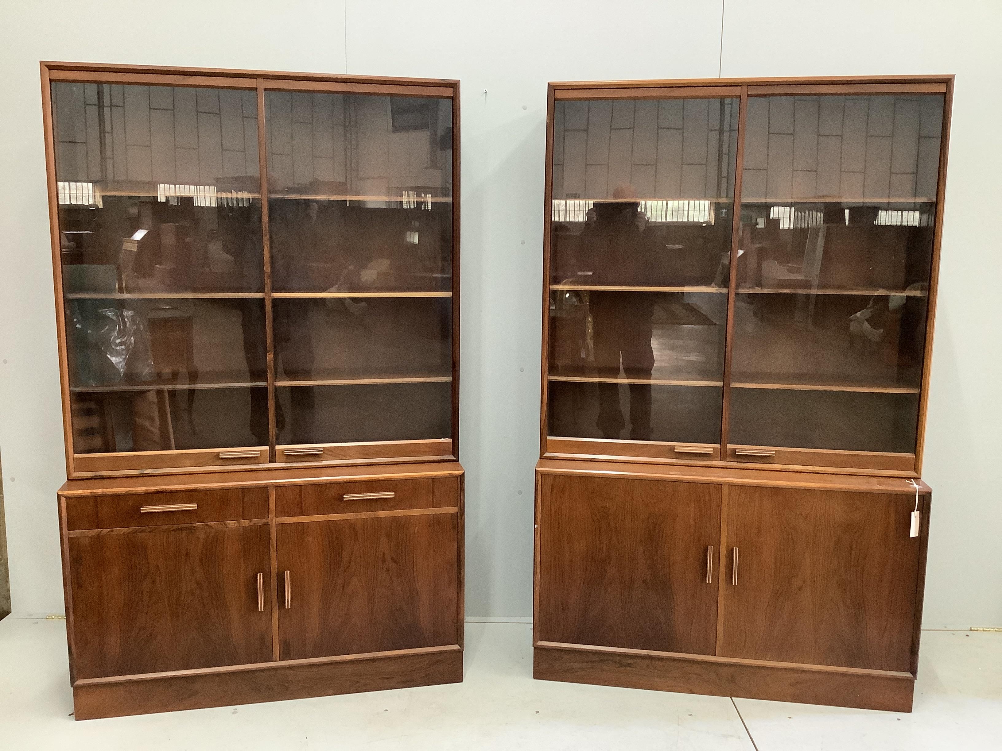 A pair of mid century Indian rosewood glazed cabinets with adjustable shelves, width 110cm, depth 38cm, height 180cm